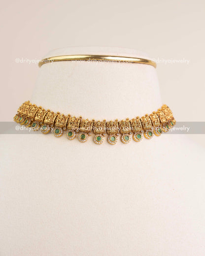 Green temple choker styled as short necklace on mannequin