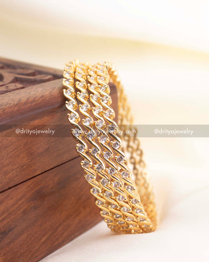 Set of premium CZ bangles stacked together, highlighting shine and wave pattern.