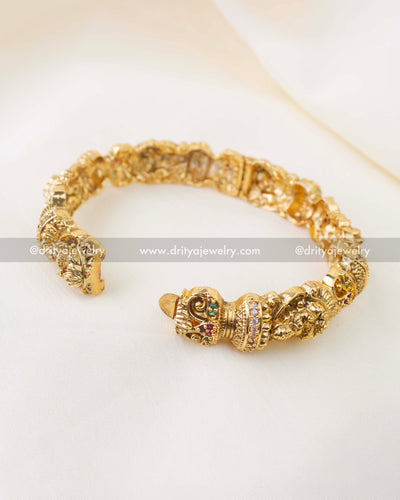 Side view of antique gold openable bangles with intricate Lakshmi temple work
