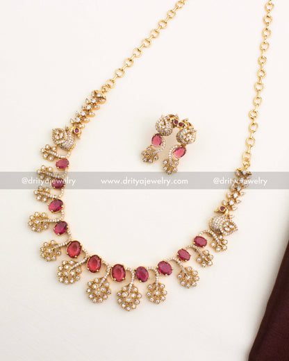 Ruby red CZ short necklace set with peacock design and AD detailing in gold polish.