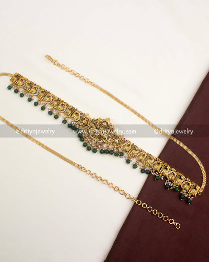 Premium gold-plated temple hip chain with Lakshmi motif and emerald green bead hangings.