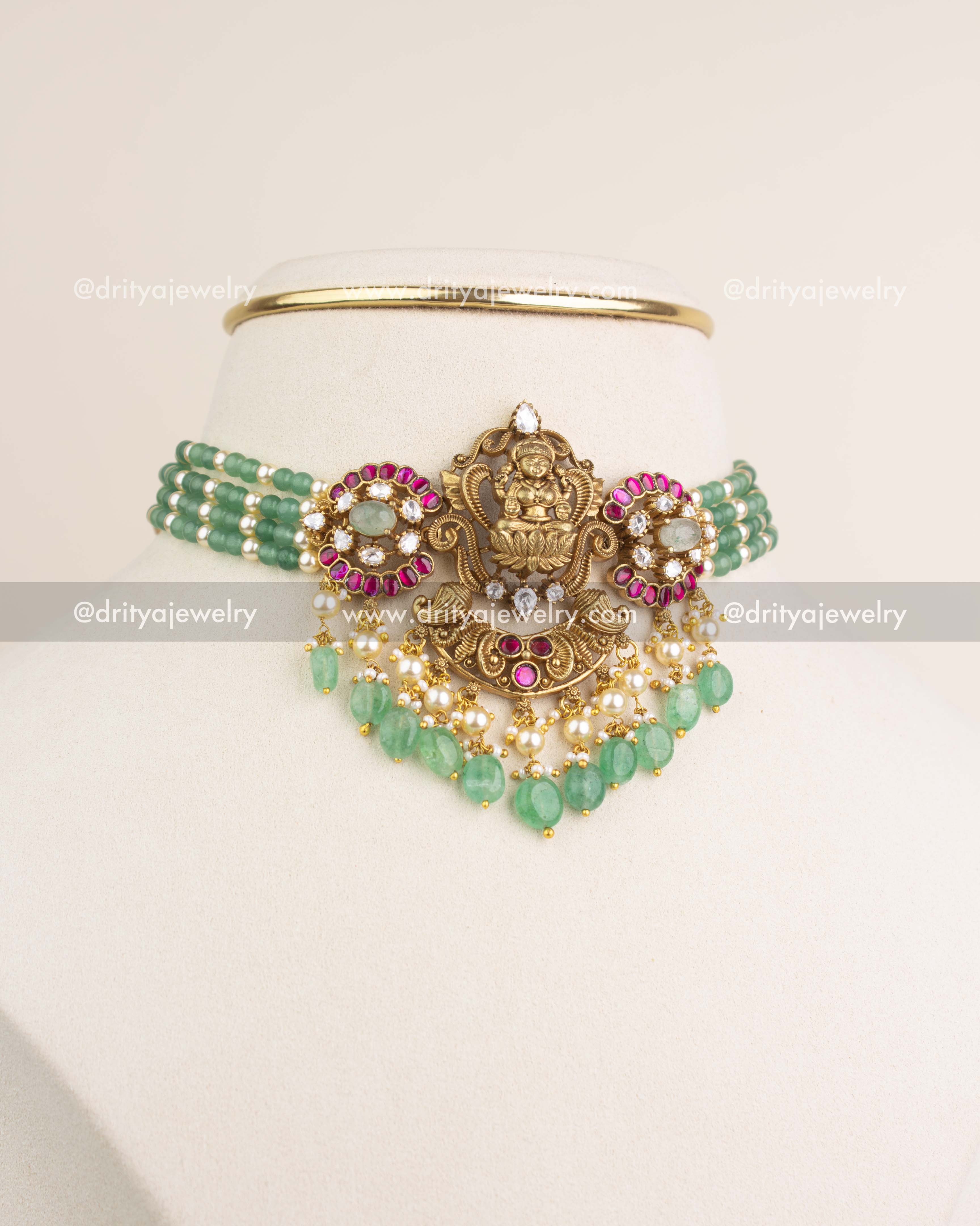 Premium Lakshmi Devi Kemp Beads Choker Set with antique gold finish and green bead strings displayed on mannequin.