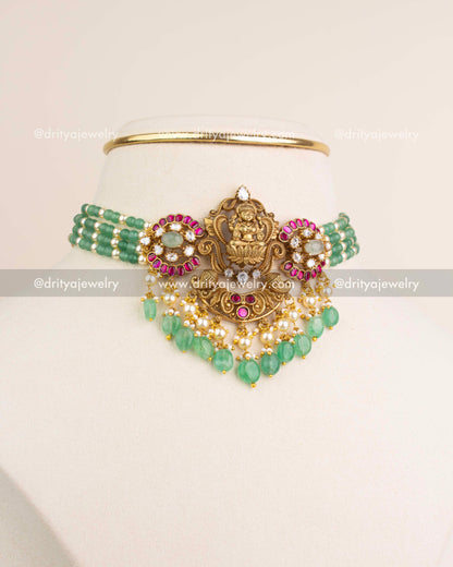 Premium Lakshmi Devi Kemp Beads Choker Set with antique gold finish and green bead strings displayed on mannequin.