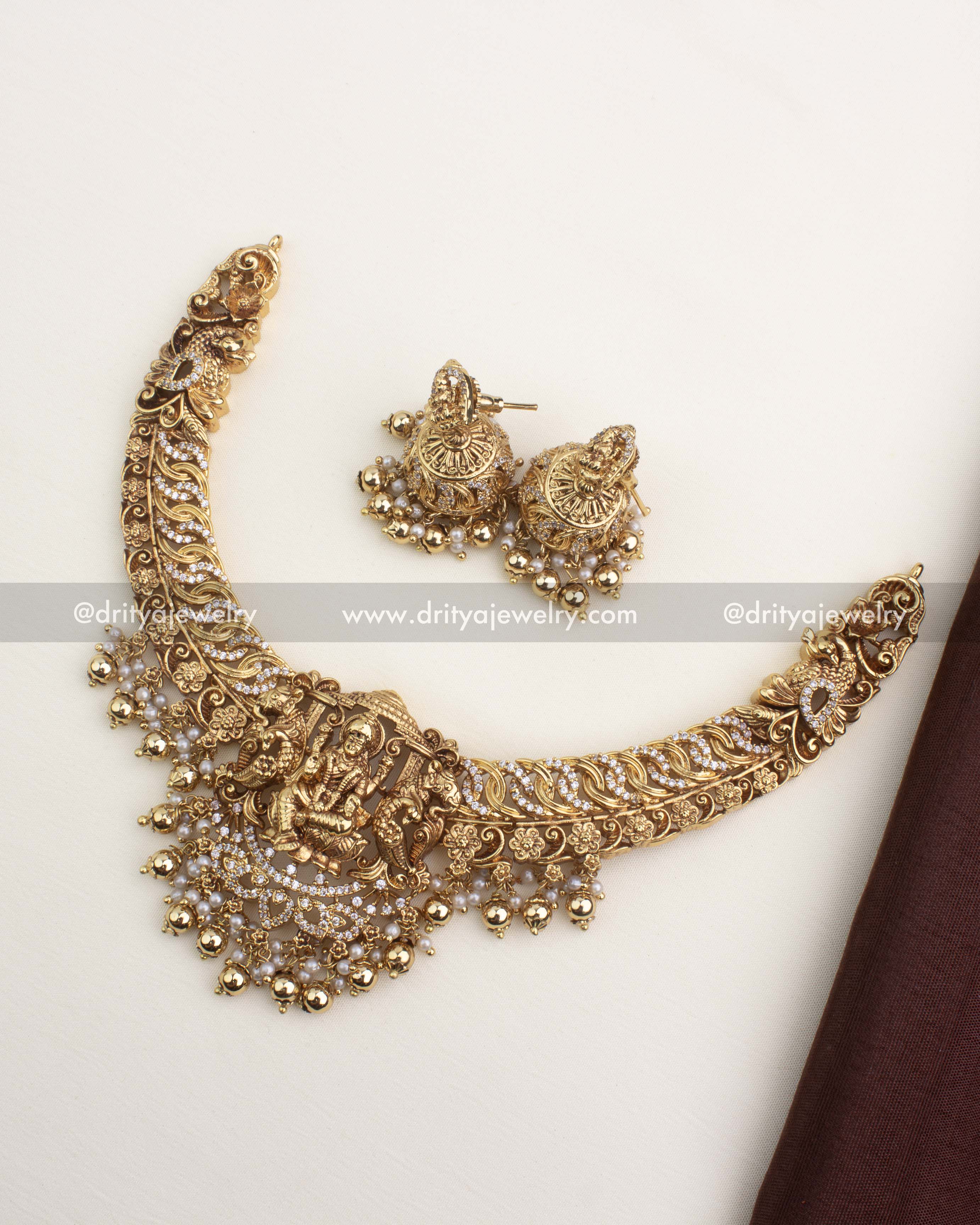 Premium temple necklace set with Lakshmi pendant, CZ jalebi work, and pearl-gold droplet hangings.
