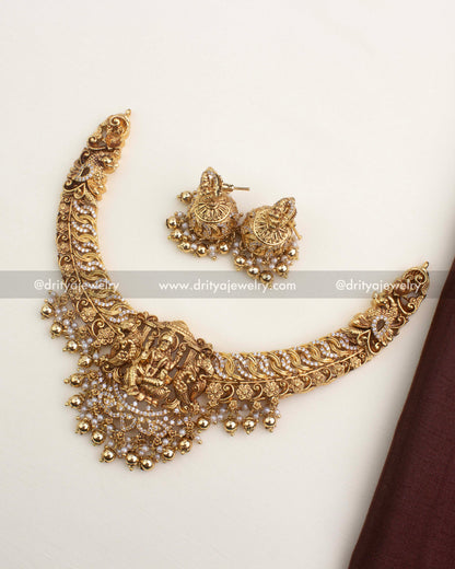 Premium temple necklace set with Lakshmi pendant, CZ jalebi work, and pearl-gold droplet hangings.