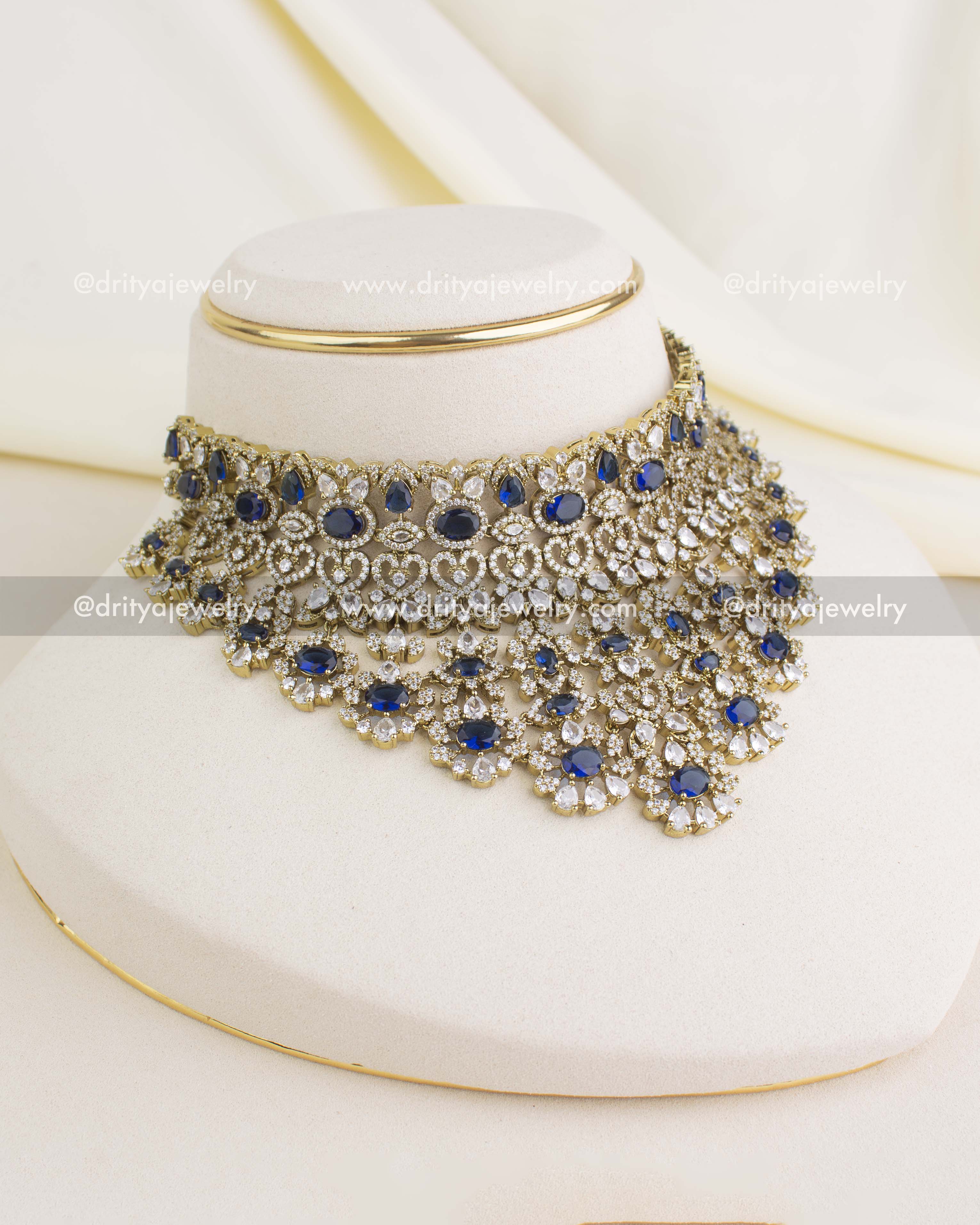 Premium Victorian bridal choker in sapphire blue with CZ stones, floral motifs, and antique gold finish.
