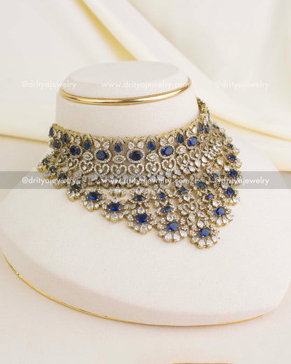 Premium Victorian bridal choker in sapphire blue with CZ stones, floral motifs, and antique gold finish.