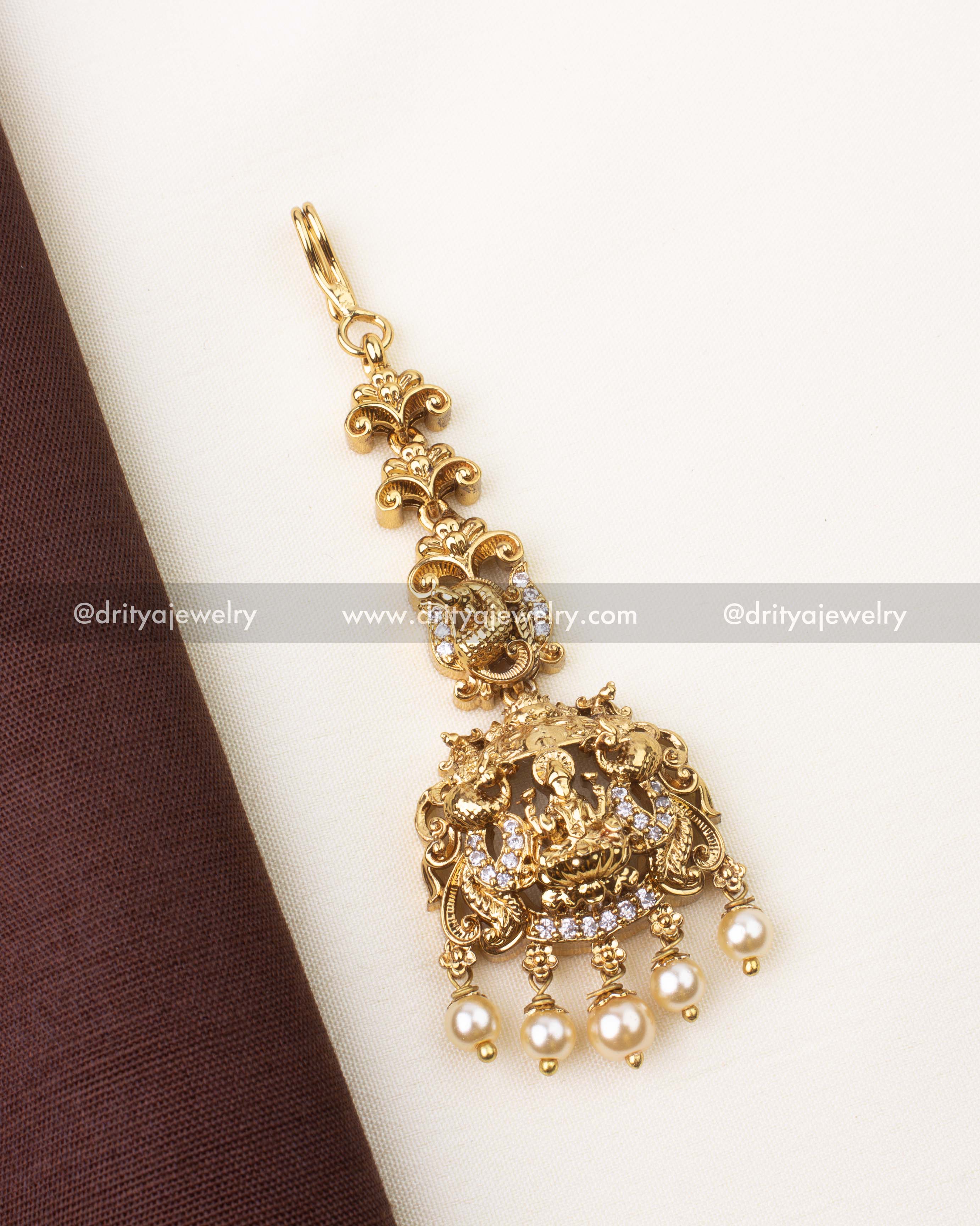 Traditional Lakshmi temple maang tikka with pearl drops and gold finish