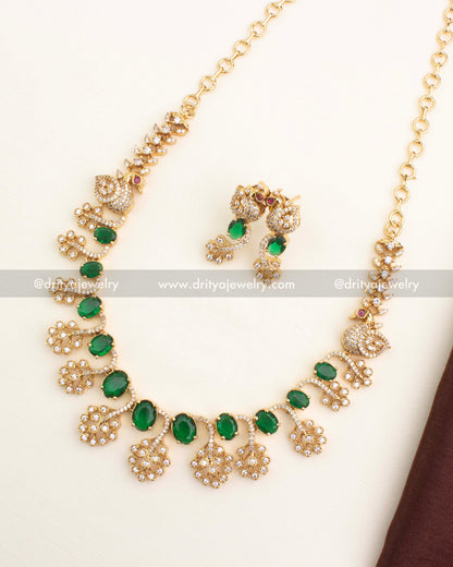 Gold-plated short necklace set with emerald green CZ stones and peacock motif design by Dritya Jewelry.