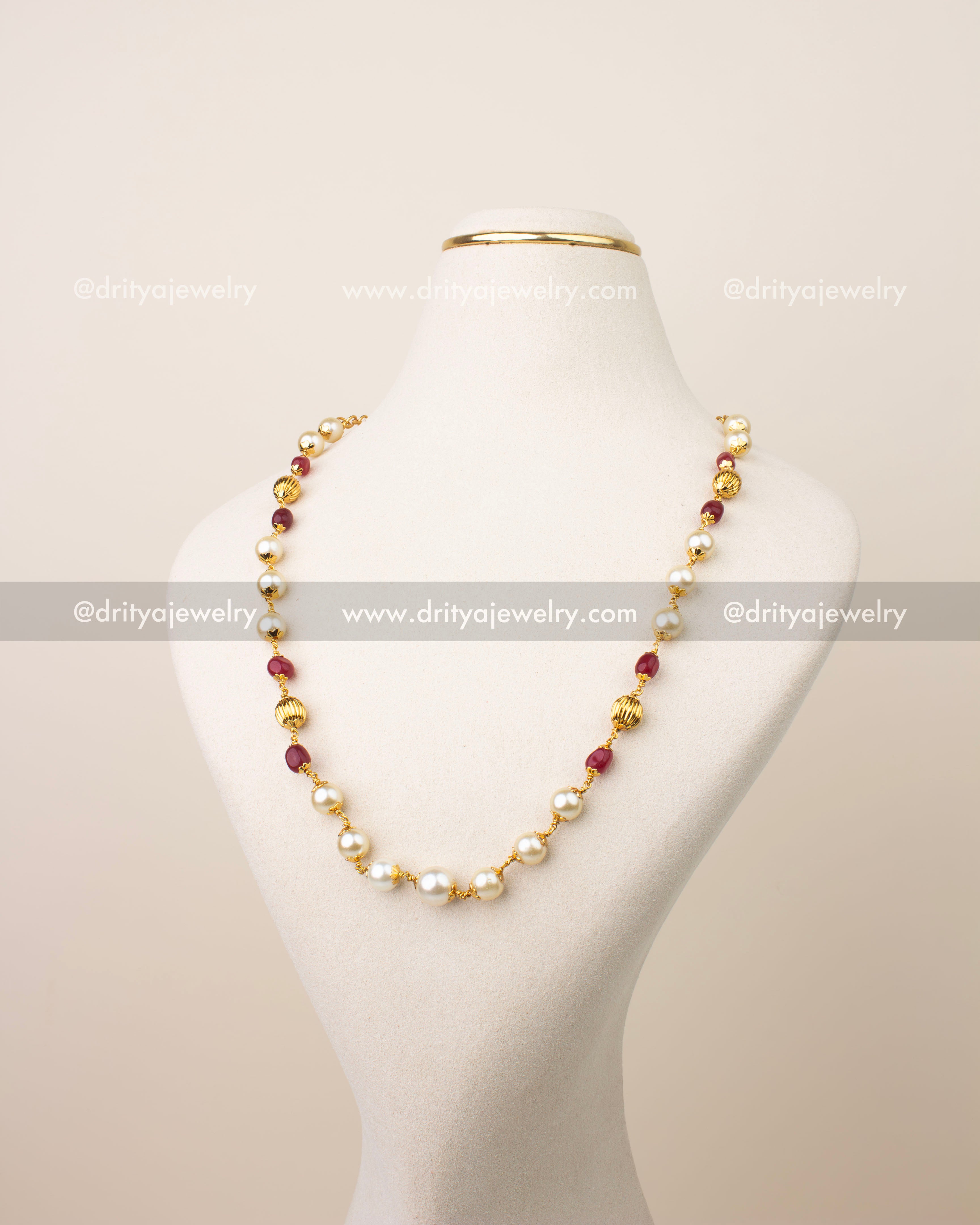 Premium pearl and ruby beads mala necklace with gold finish displayed on mannequin