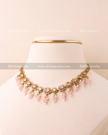 Blush pink choker necklace with AD stones and bead danglers in antique gold finish.