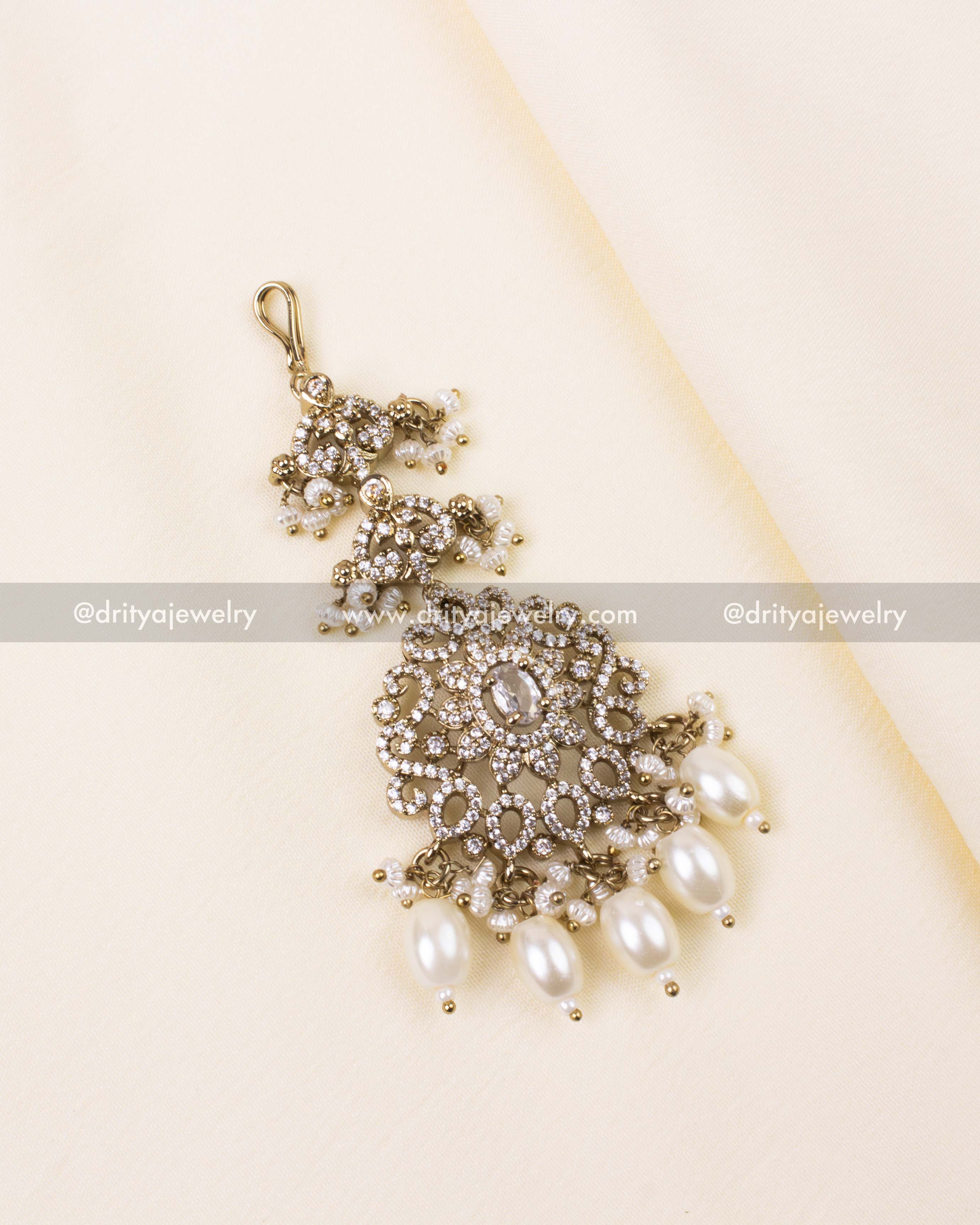 Elegant Victorian maang tikka with diamond-like CZ stones and white pearl drops.