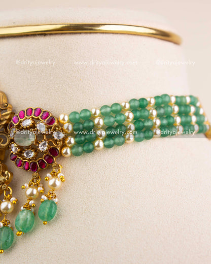 Close-up of multi-layer green beads and pearls on Lakshmi Devi temple choker.