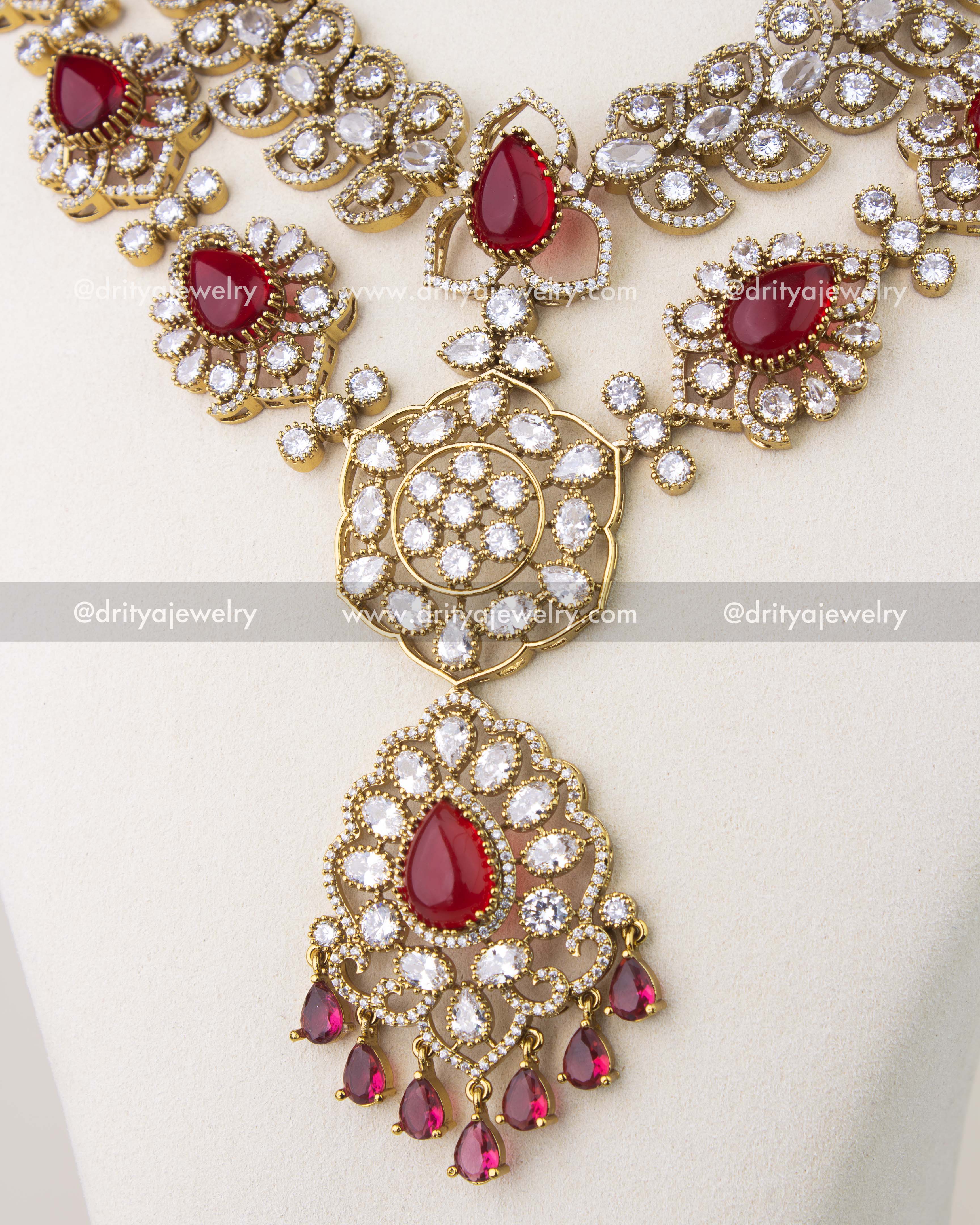 Cushion cut red stones framed with CZ in Victorian gold polish