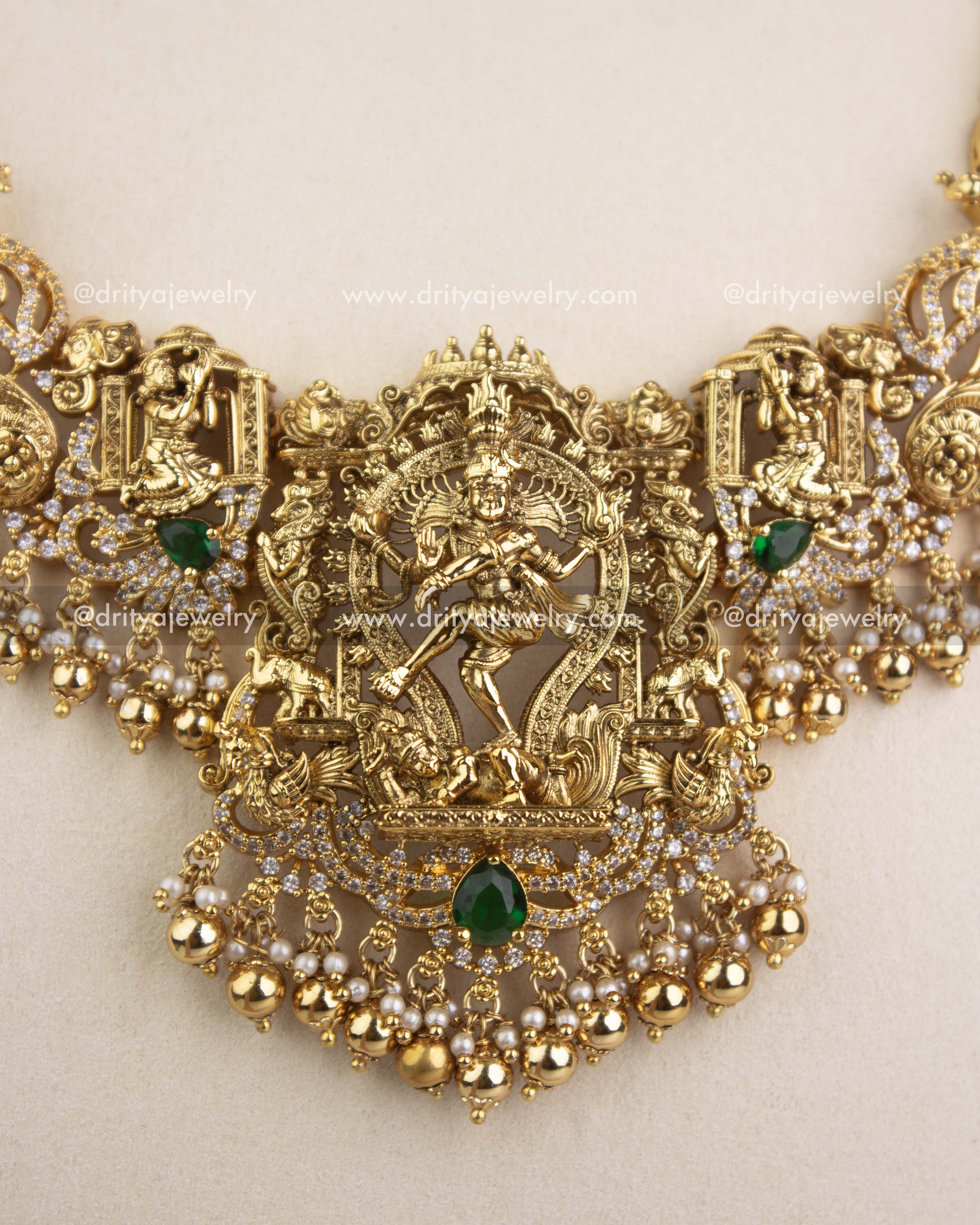 Detailed close-up of Nataraja pendant with emerald stones, CZ work, and pearl clusters.
