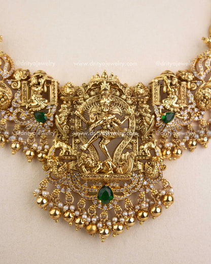 Detailed close-up of Nataraja pendant with emerald stones, CZ work, and pearl clusters.