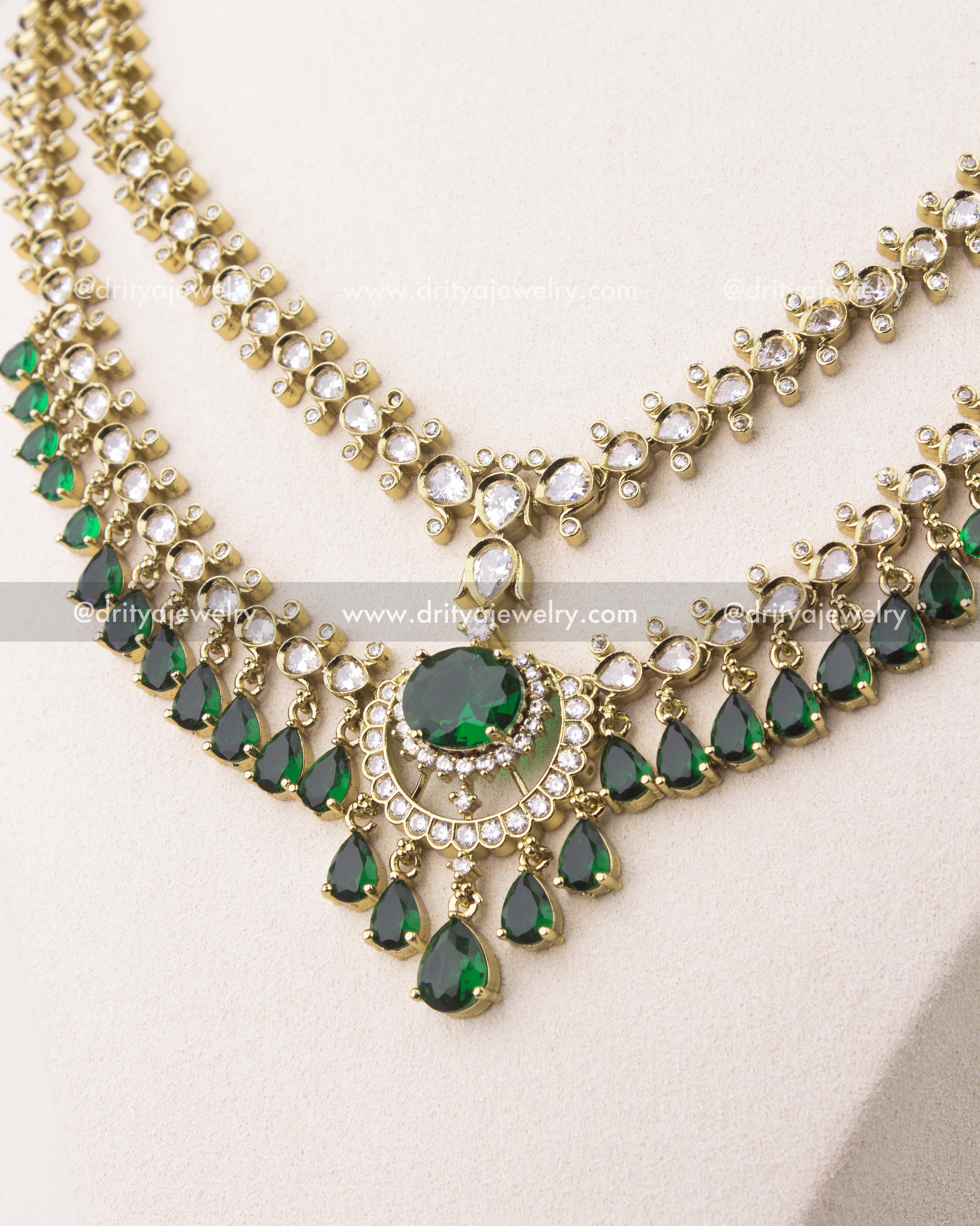 close up of Victorian layered short necklace set with emerald green stones and gold finish