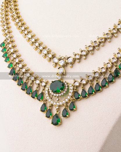 close up of Victorian layered short necklace set with emerald green stones and gold finish
