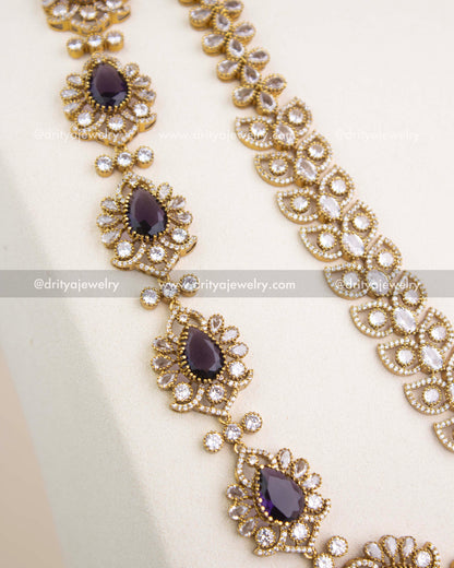Close-up of Victorian chain pattern with teardrop CZ stones and intricate floral detailing in antique gold.