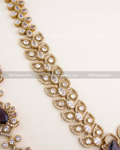 Close-up of Victorian chain pattern with teardrop CZ stones and intricate floral detailing in antique gold.