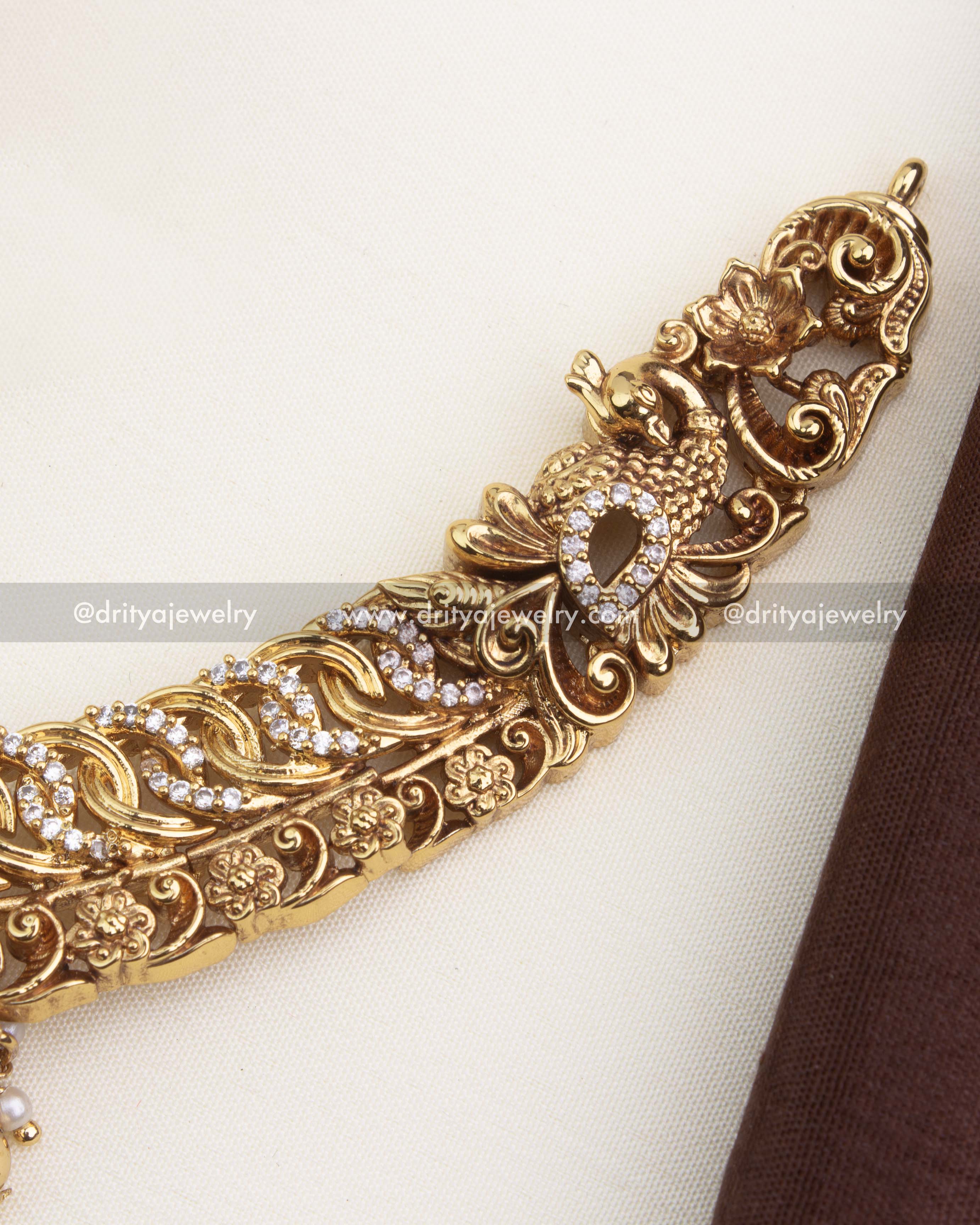 Intricate side detailing with peacock, floral motifs, and sparkling CZ jalebi stonework.