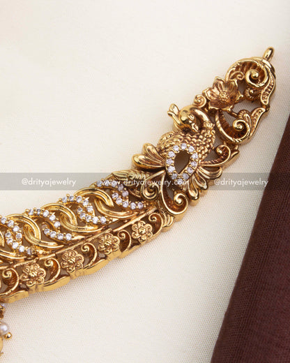 Intricate side detailing with peacock, floral motifs, and sparkling CZ jalebi stonework.