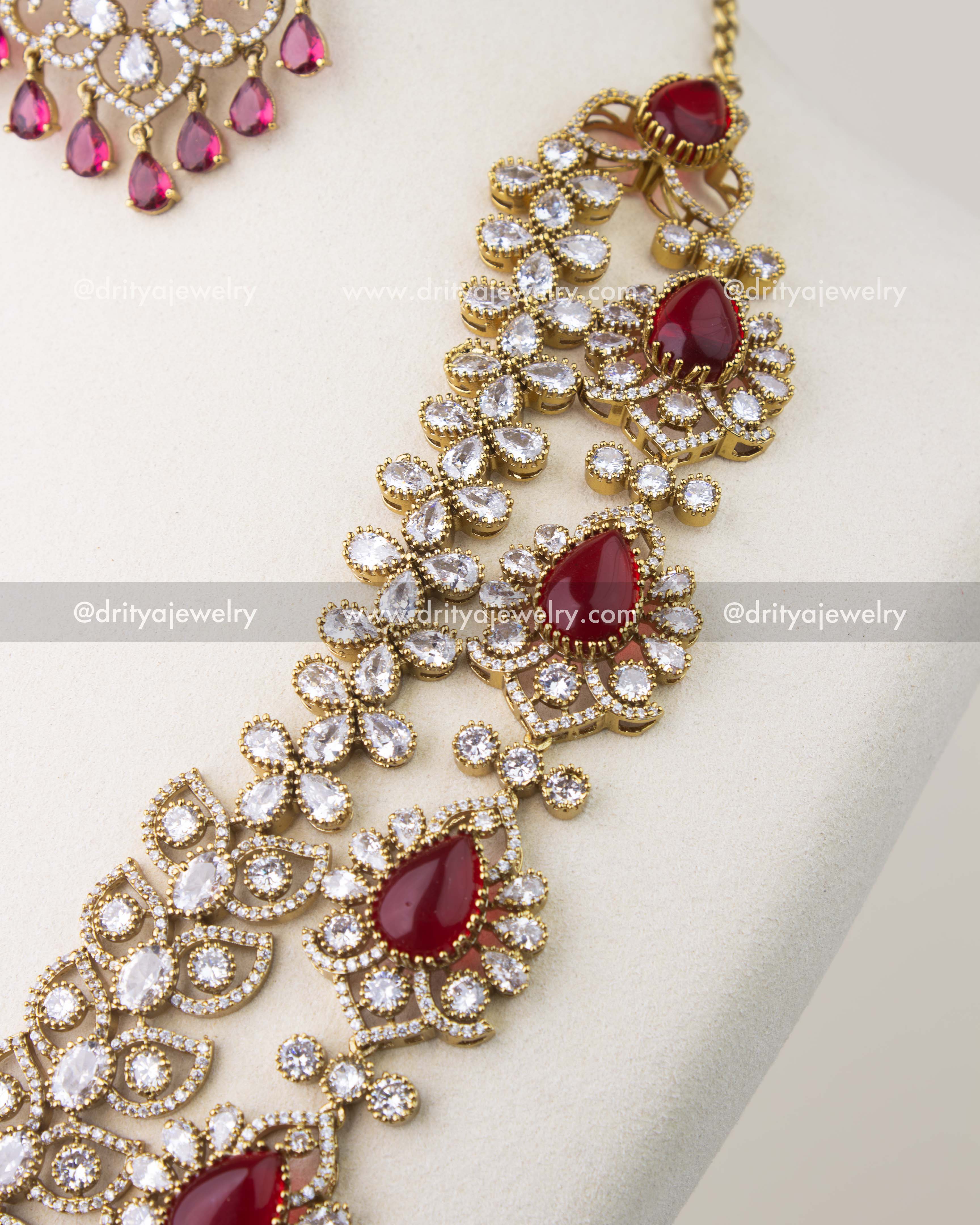 Cushion cut red stones framed with CZ in Victorian gold polish