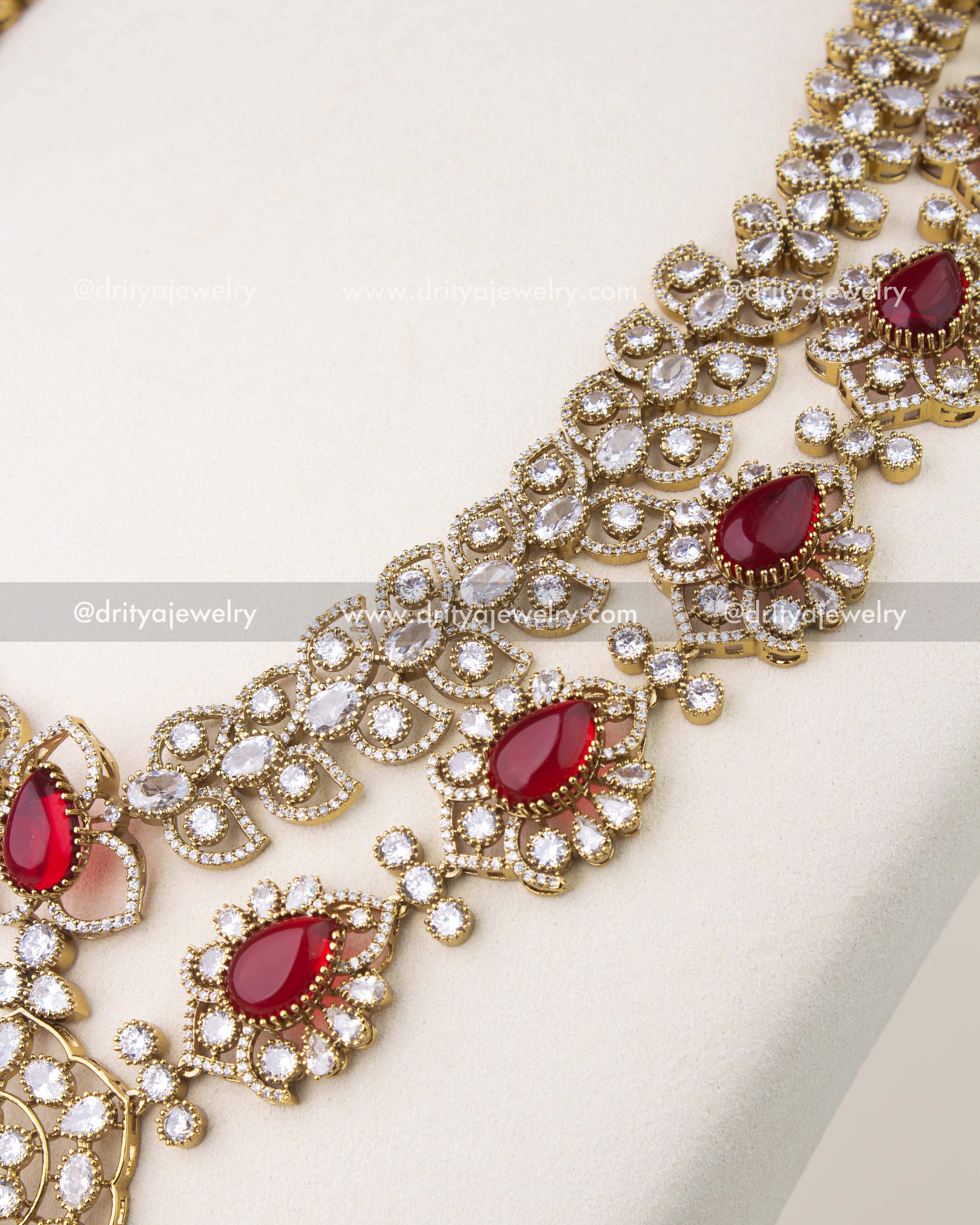 Cushion cut red stones framed with CZ in Victorian gold polish