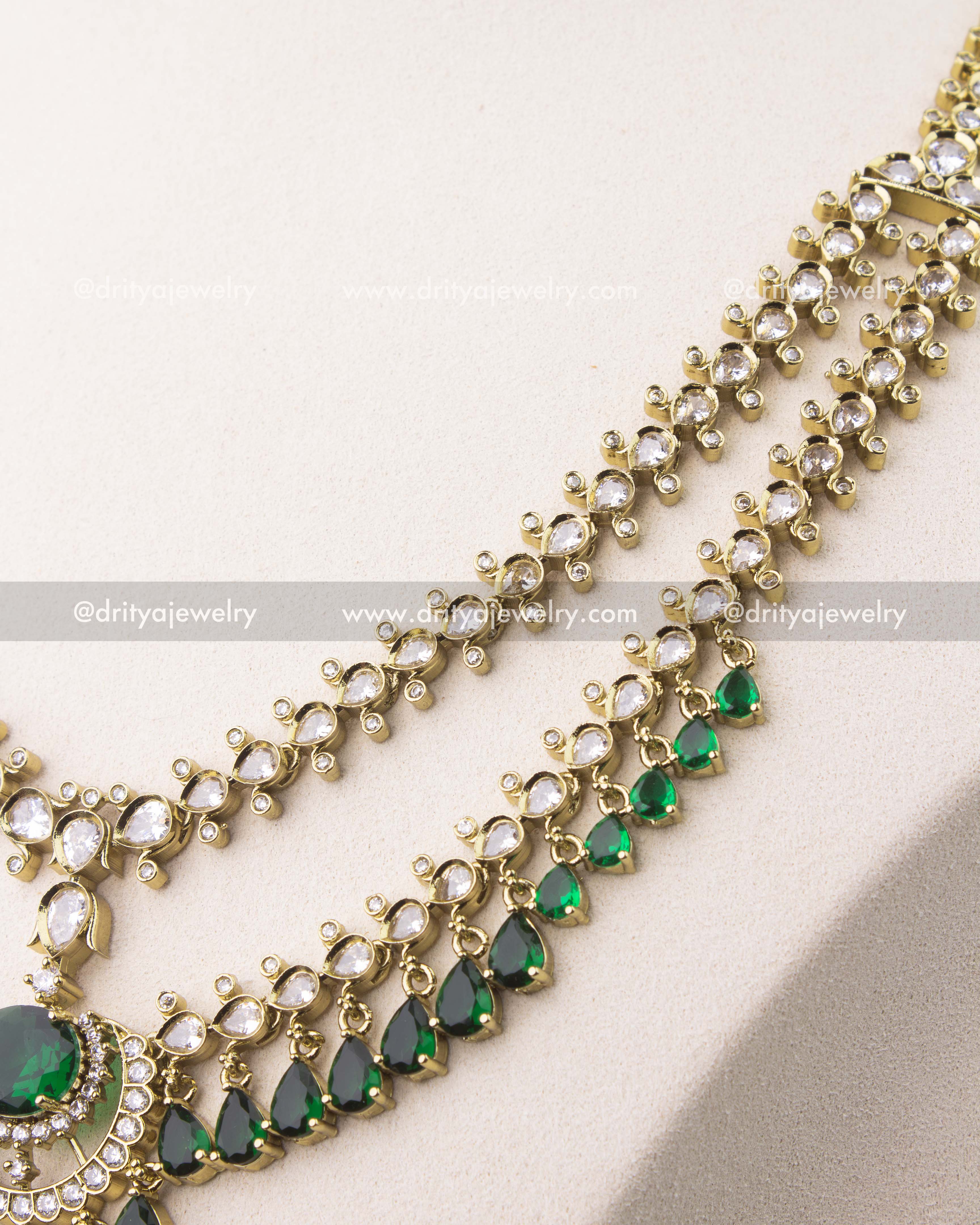 close up of Victorian layered short necklace set with emerald green stones and gold finish
