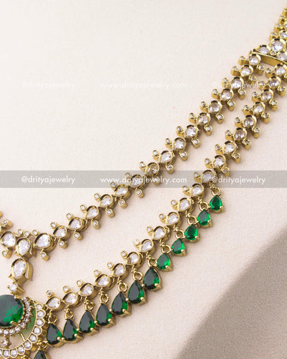 close up of Victorian layered short necklace set with emerald green stones and gold finish