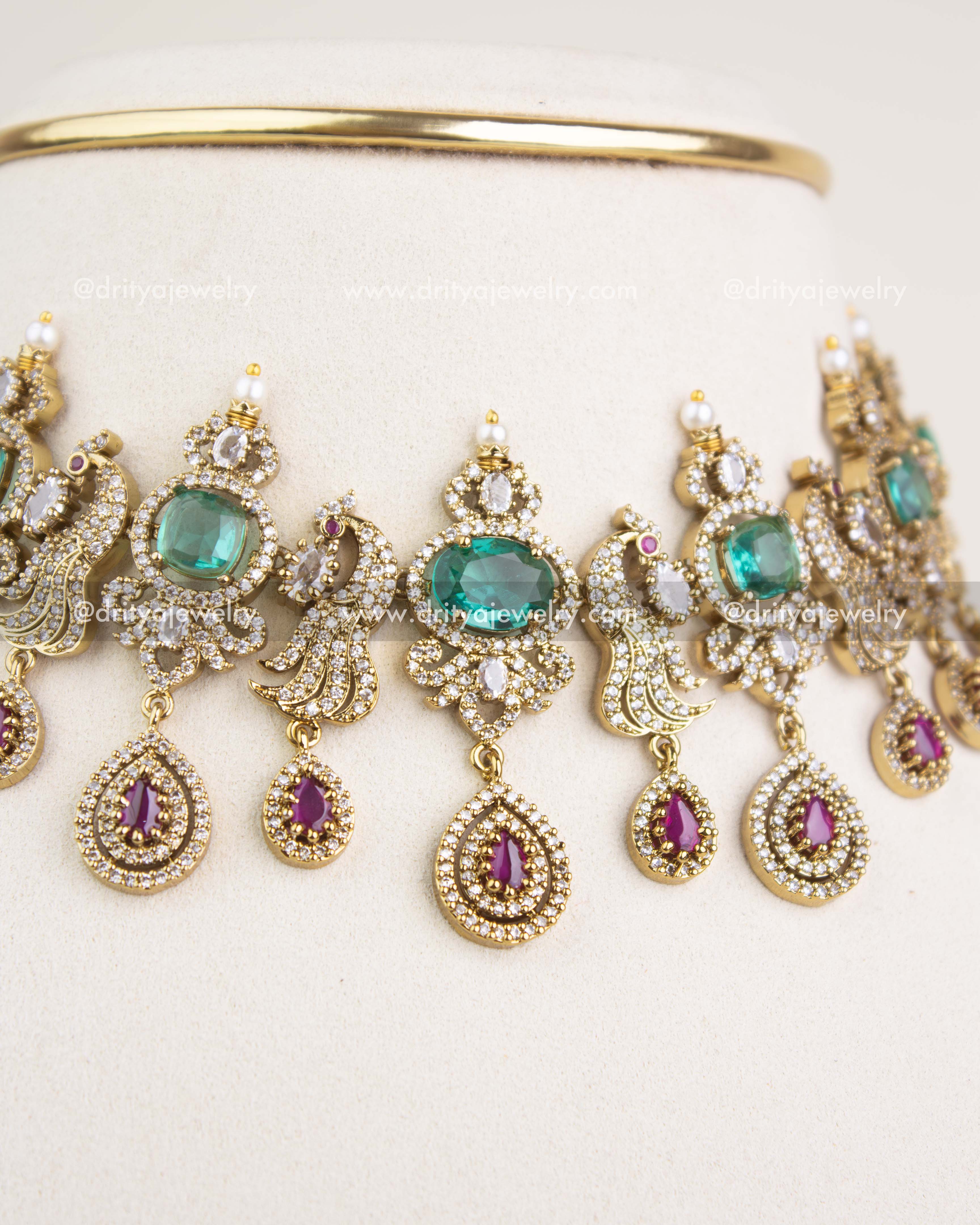 Close-up of Russian emerald stones, CZ clusters, pearl enhancements, and antique Victorian craftsmanship.