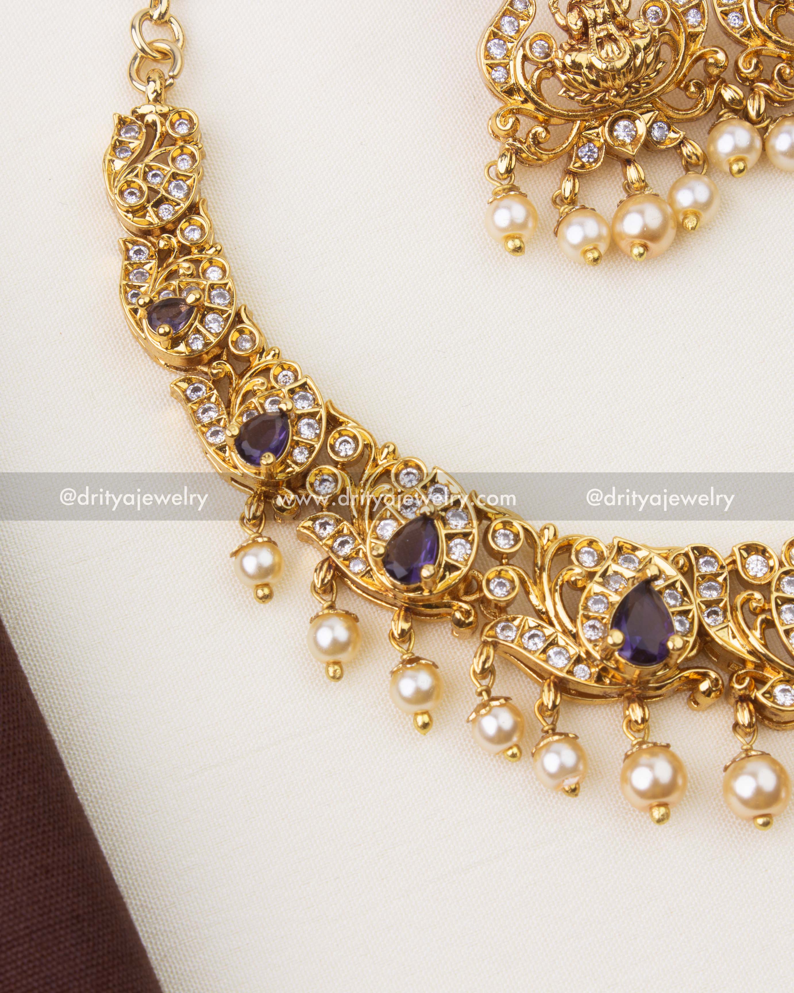 Close-up of Nakshi temple necklace featuring purple stones, CZ accents and pearl hangings