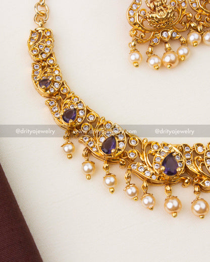 Close-up of Nakshi temple necklace featuring purple stones, CZ accents and pearl hangings