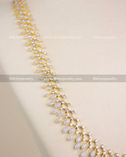 Close-up of CZ-studded leaf design in GJ polish long necklace.