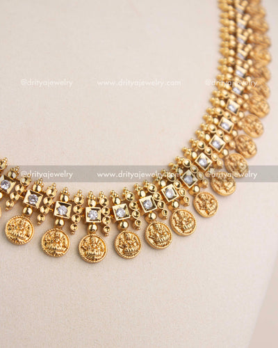 High-detail close-up highlighting embossed Lakshmi coins and beadwork on the temple necklace.