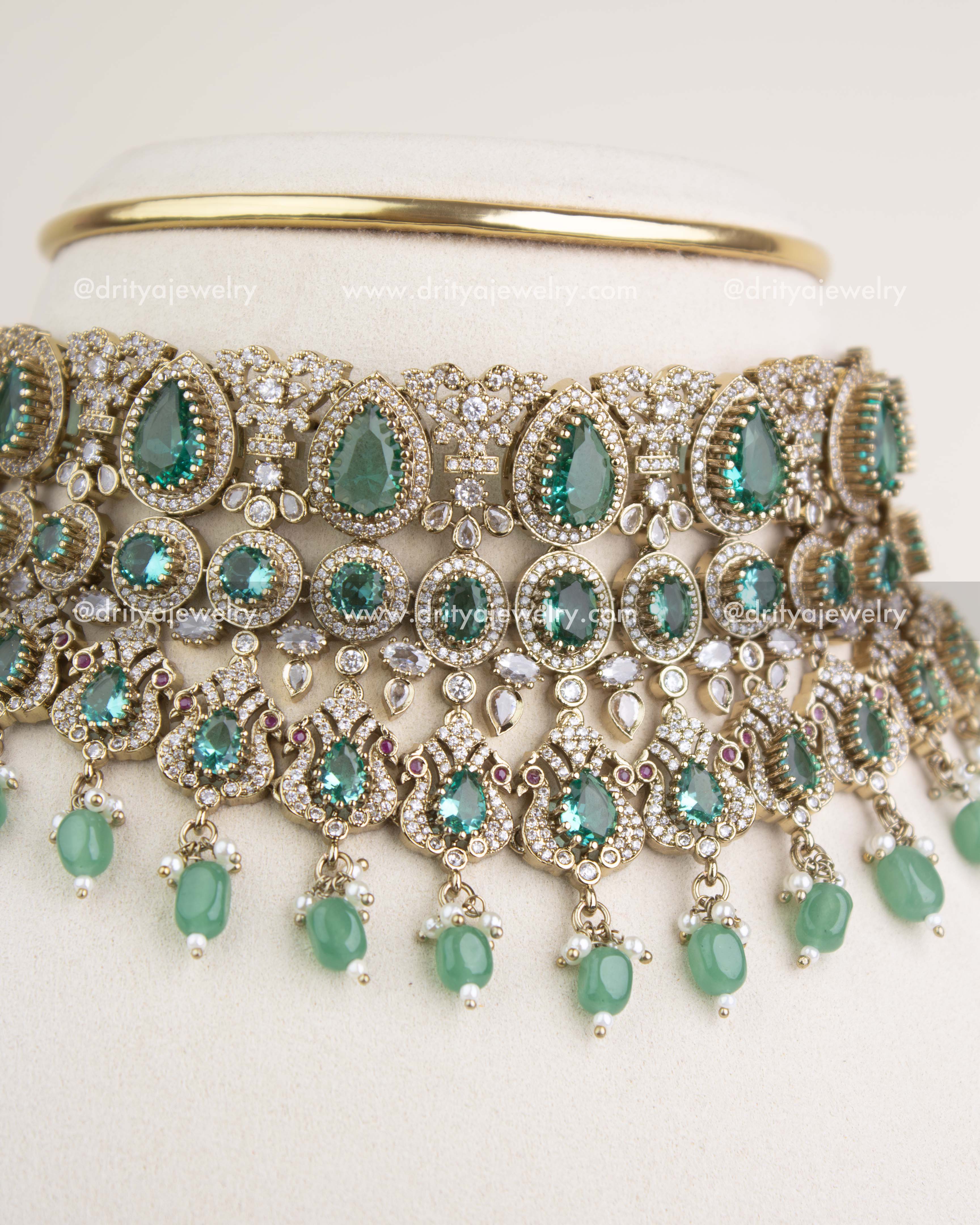 Close-up view of Russian emerald stones, teardrop motifs, and intricate Victorian filigree craftsmanship.