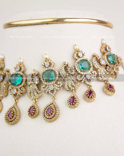 Detailed view of pear-shaped ruby drops, emerald clusters, and multi-layer Victorian motifs.