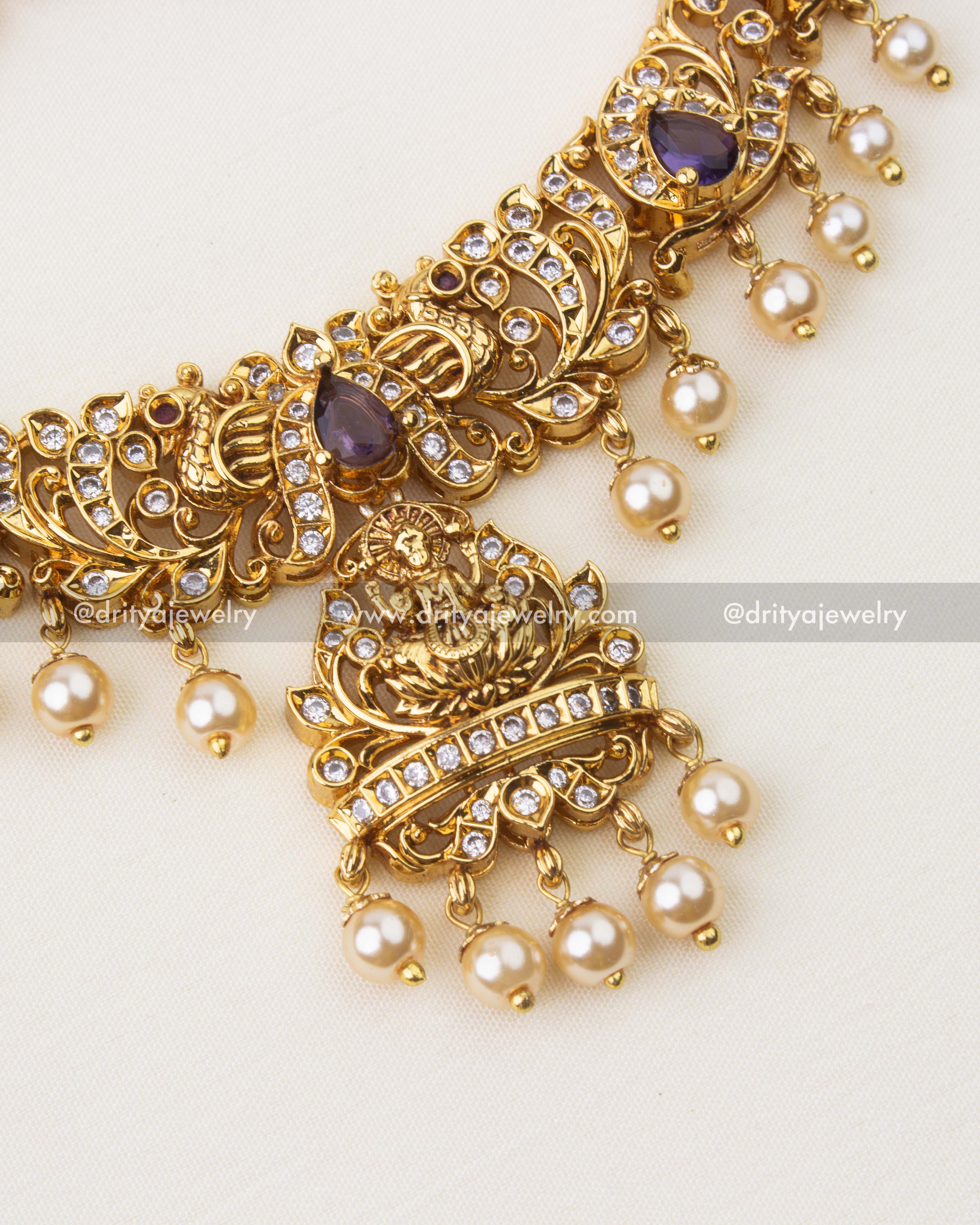 Close-up of Nakshi temple necklace featuring purple stones, CZ accents and pearl hangings