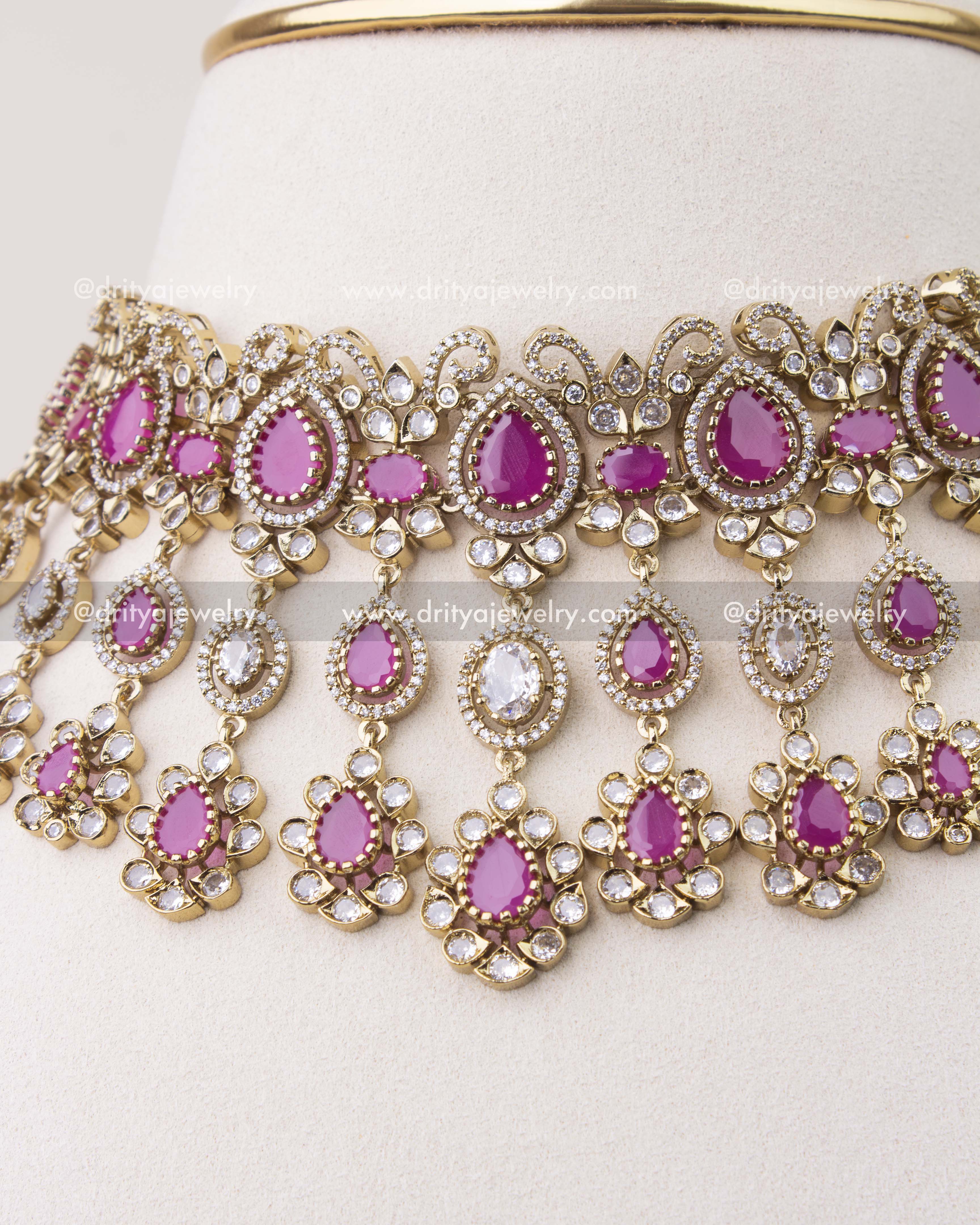 Close-up of ruby pink Victorian choker with intricate CZ stone work and hanging motifs