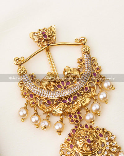 Close-up of ruby red stone detailing and pearl hangings on traditional long jada billa