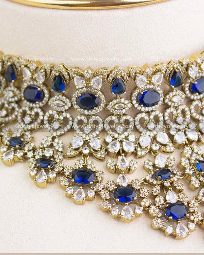 Close-up image of sapphire blue Victorian choker showcasing floral clusters, teardrop stones, and micro AD setting.