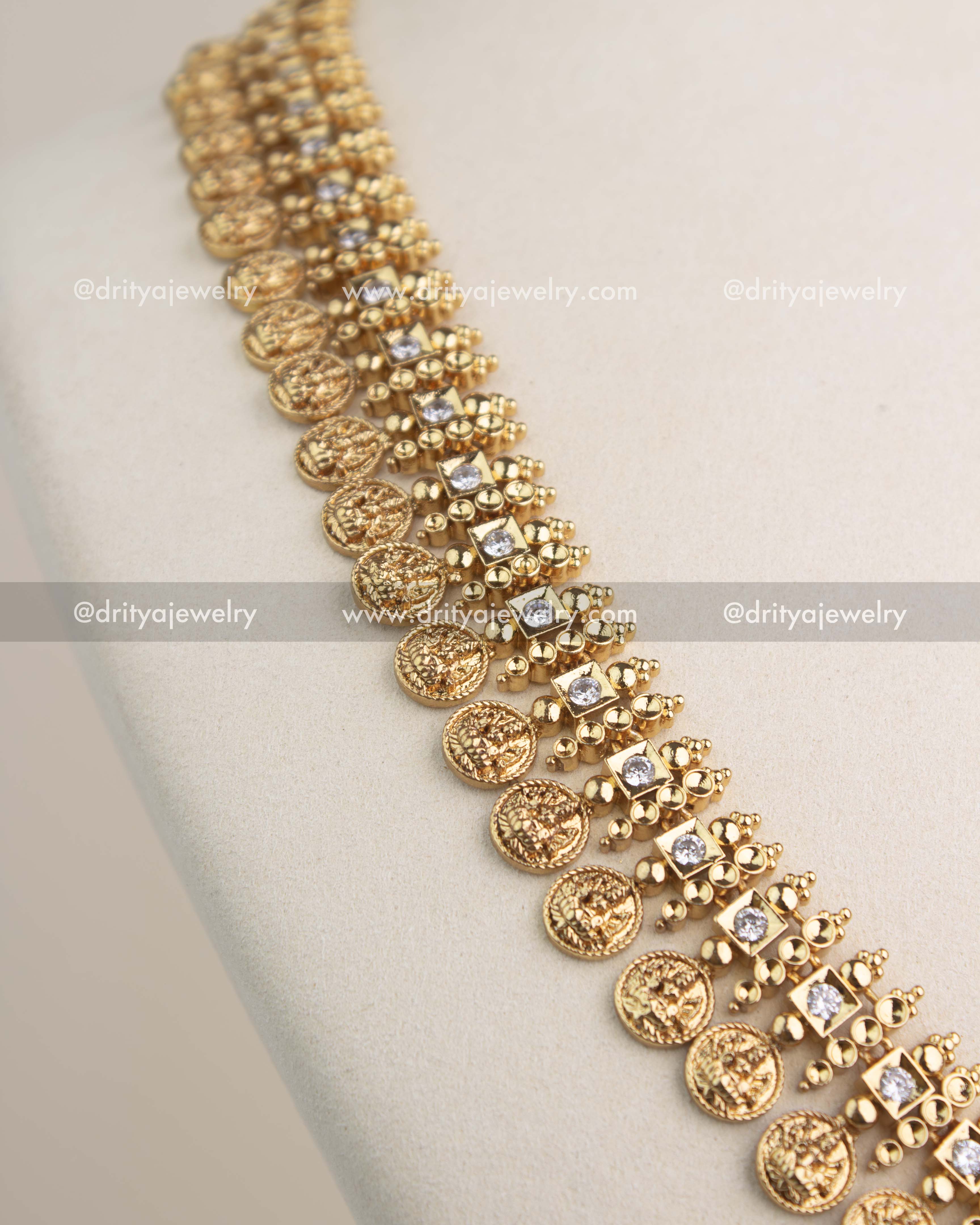Close-up shot showing CZ stones and Lakshmi kasulu coin detailing on the temple long necklace.
