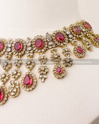Close-up of ruby red stones with Victorian gold polish necklace