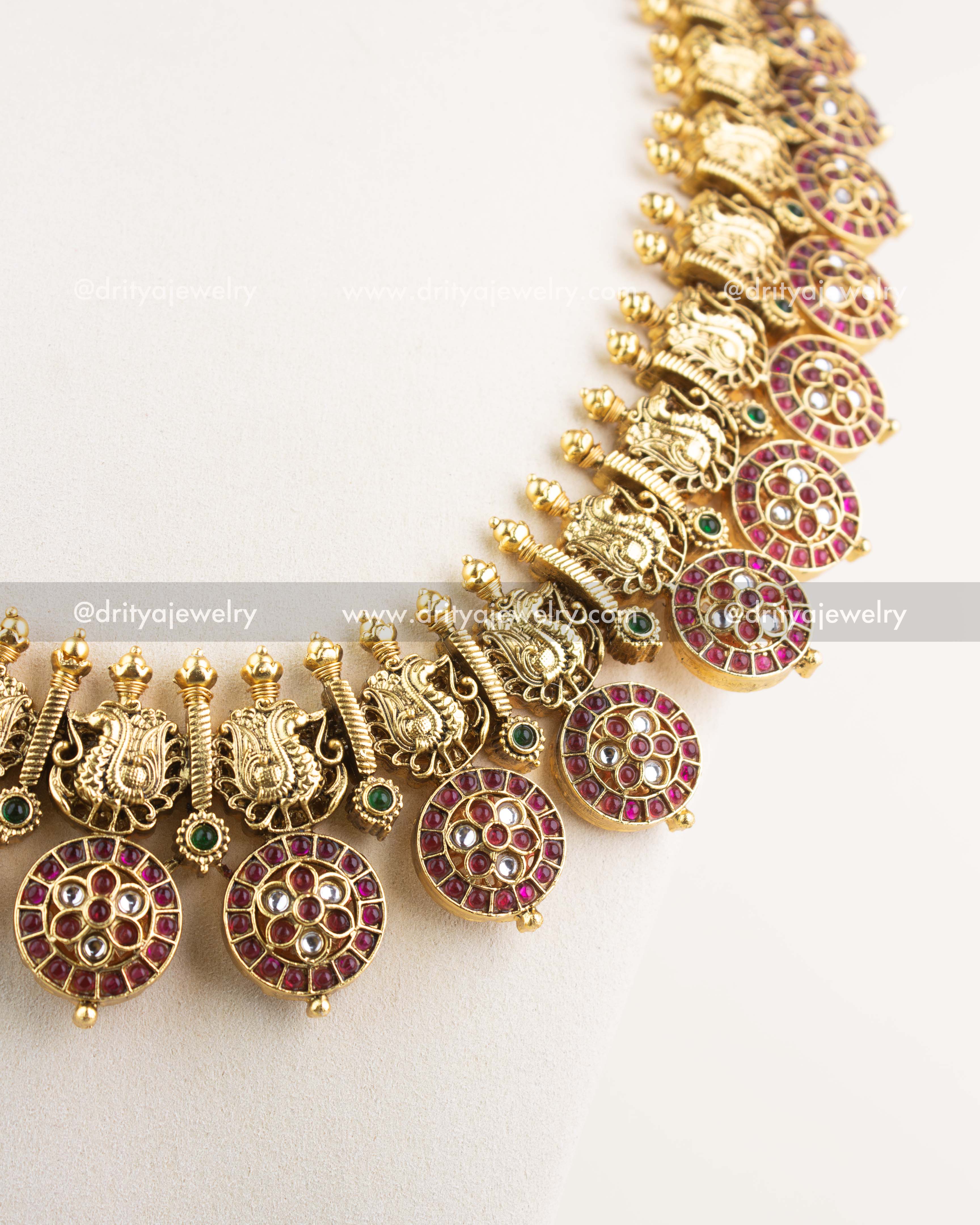 Side view of Bottu Mala highlighting peacock engravings, ruby stones, and temple-style workmanship.