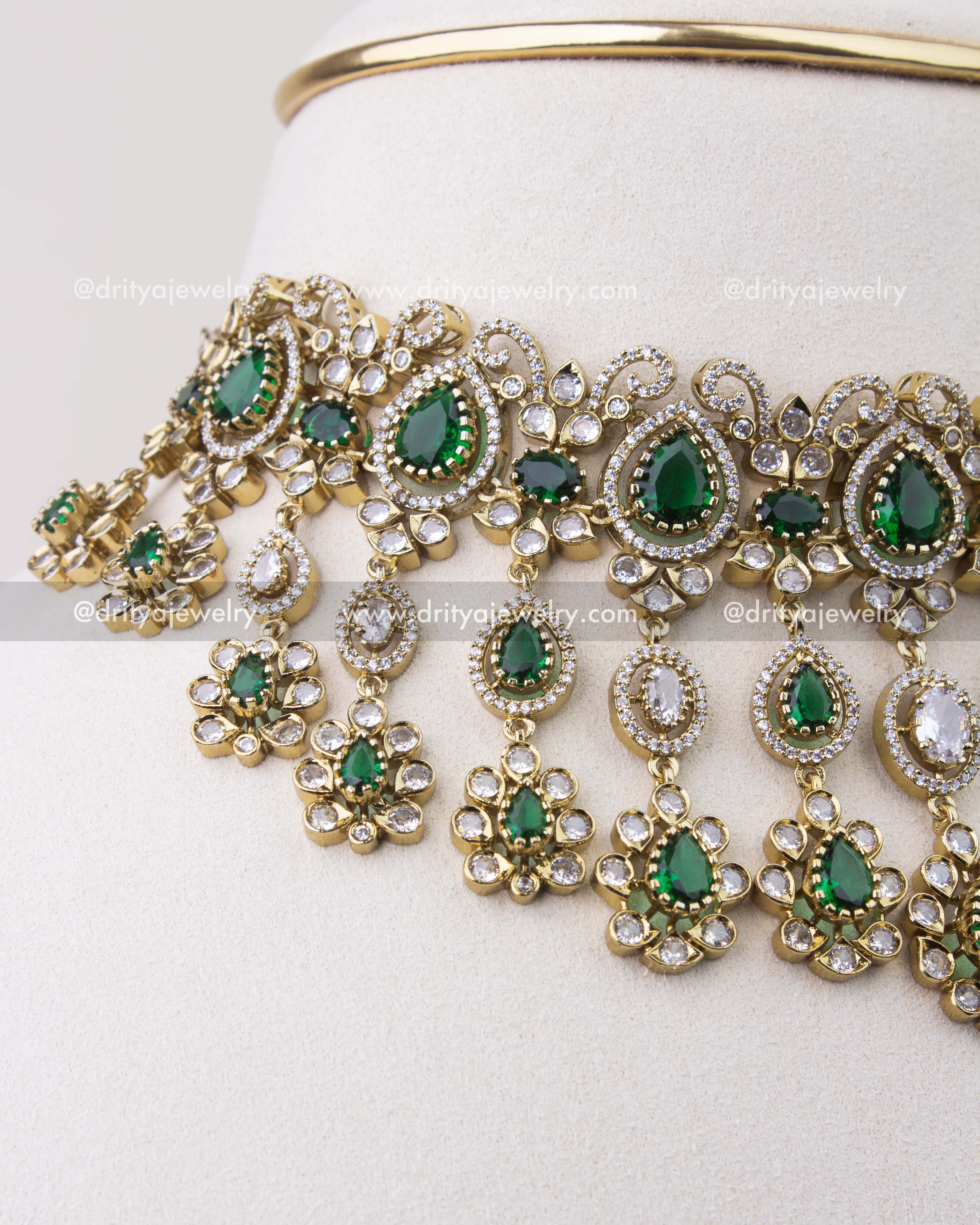 Close-up of emerald green Victorian choker with teardrop stones and dangling CZ elements