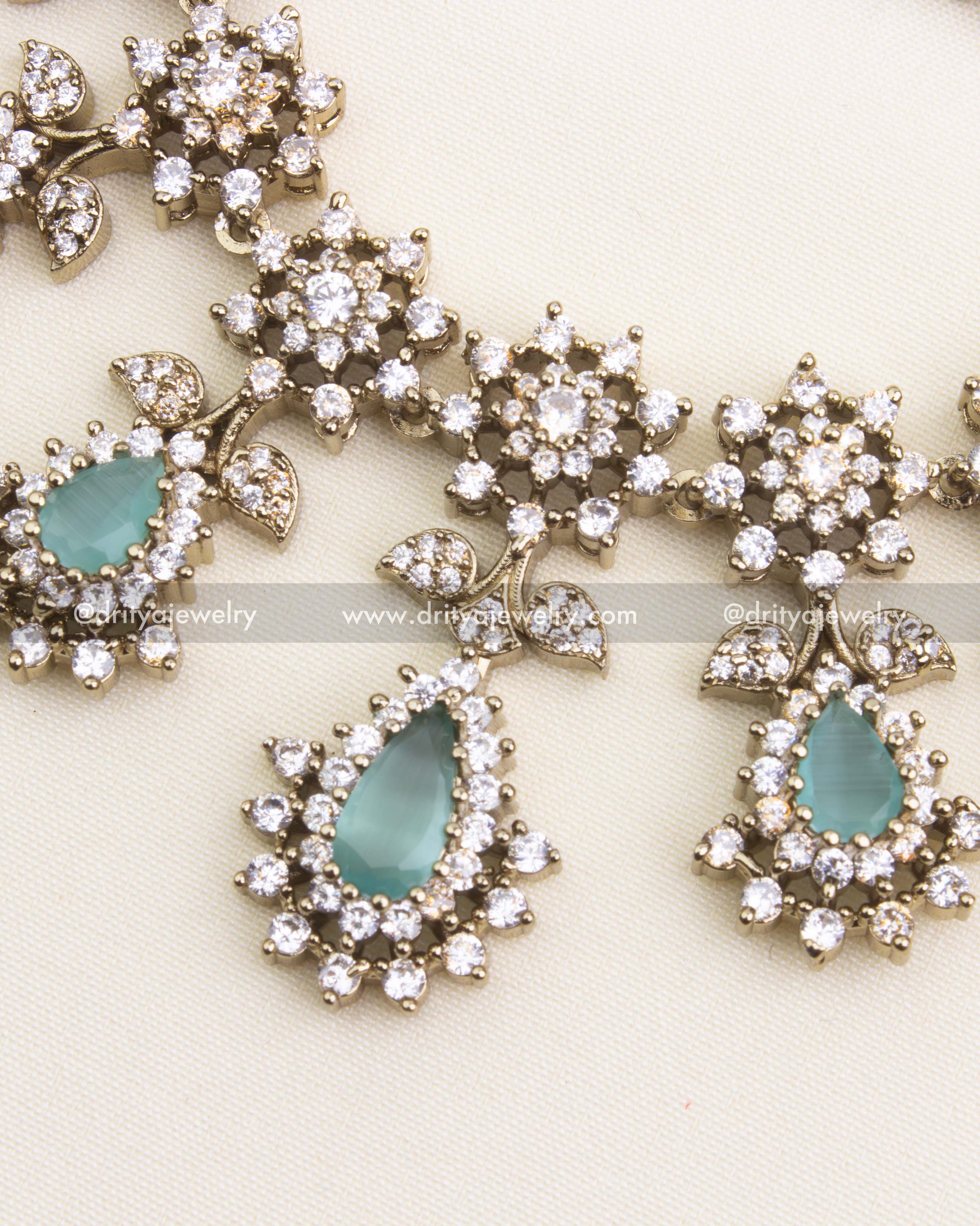 Detailing of Mint Teardrop Stones and Floral Motifs in Necklace