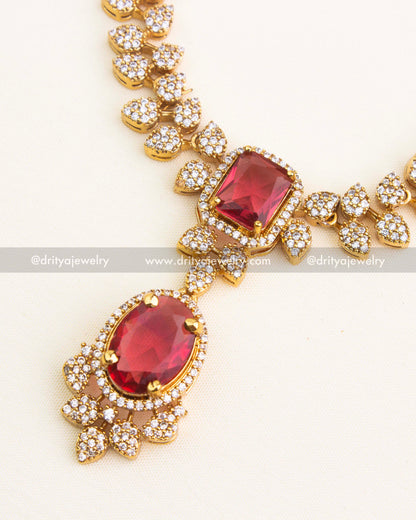 Close-up of red oval pendant and cushion-cut centerpiece.