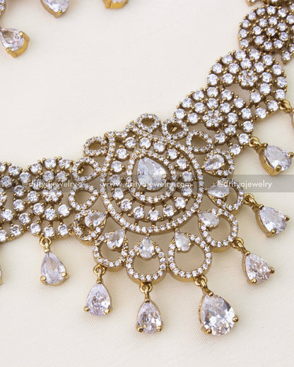 Close-up of Victorian gold polished necklace with teardrop CZ center and dangling stones