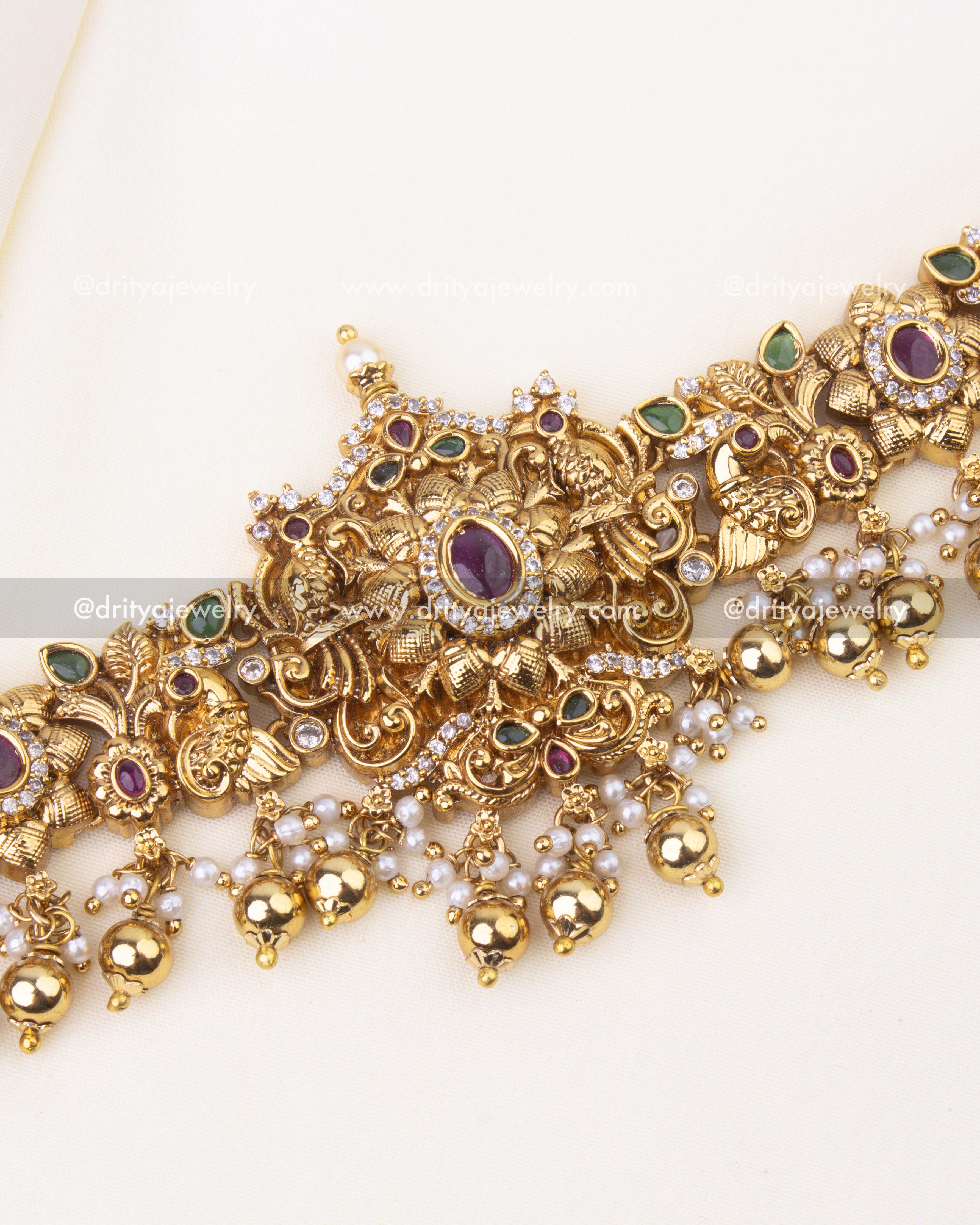 Central floral Nakshi design with ruby and emerald stones