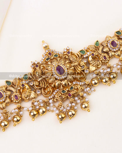 Central floral Nakshi design with ruby and emerald stones